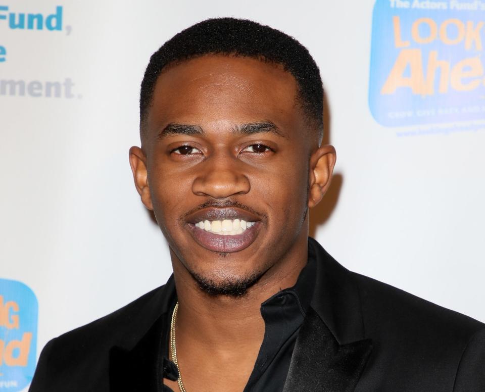 Malcolm David Kelley smiles at red carpet event