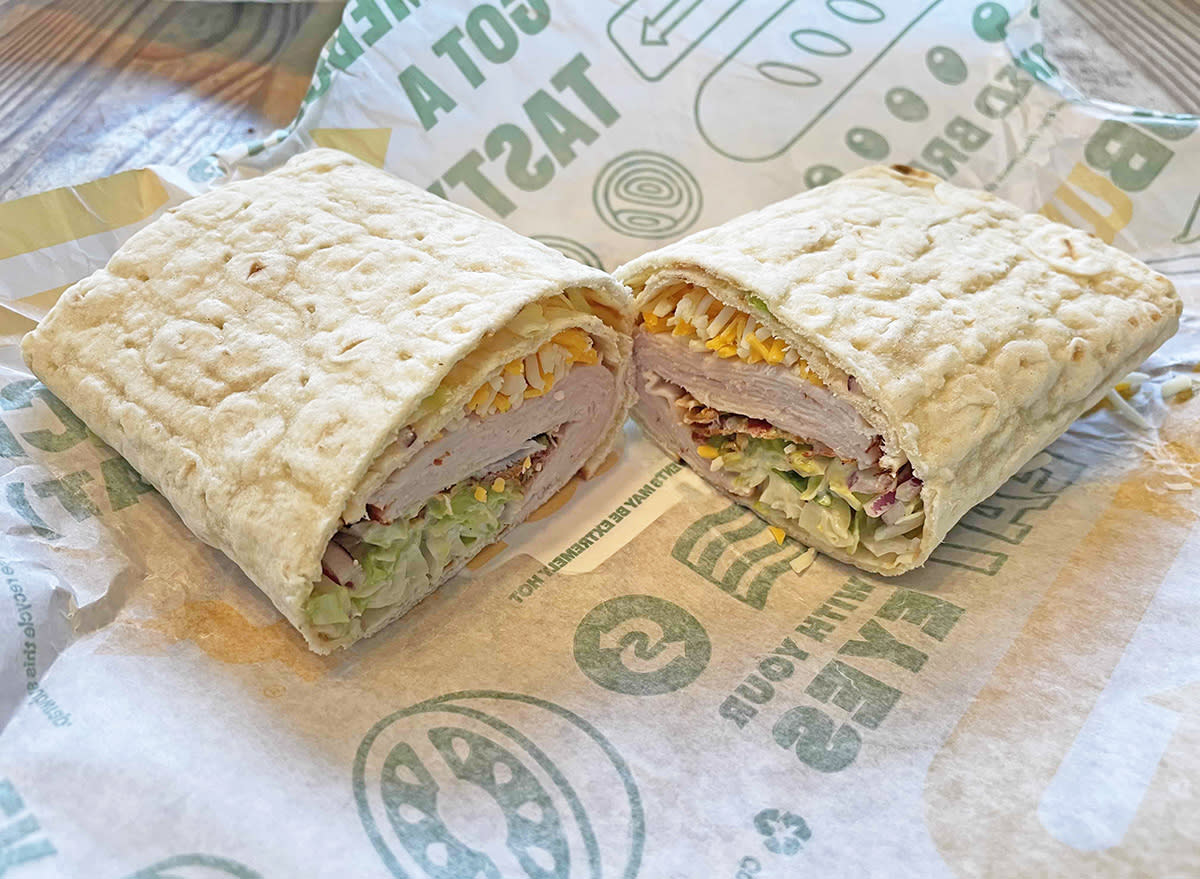 The new Turkey Bacon Avocado flatbread wrap from Subway, cut in half on its wrapper