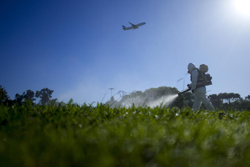 A public health worker fumigates as part of a campaign against dengue-promoting mosquitoes, in Buenos Aires, Argentina, April 5, 2024. (AP Photo/Natacha Pisarenko)