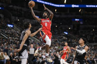 New Orleans Pelicans' Naji Marshall (8) shoots against San Antonio Spurs' Devin Vassell (24) during the second half of an NBA basketball game, Friday, Dec. 2, 2022, in San Antonio. (AP Photo/Darren Abate)