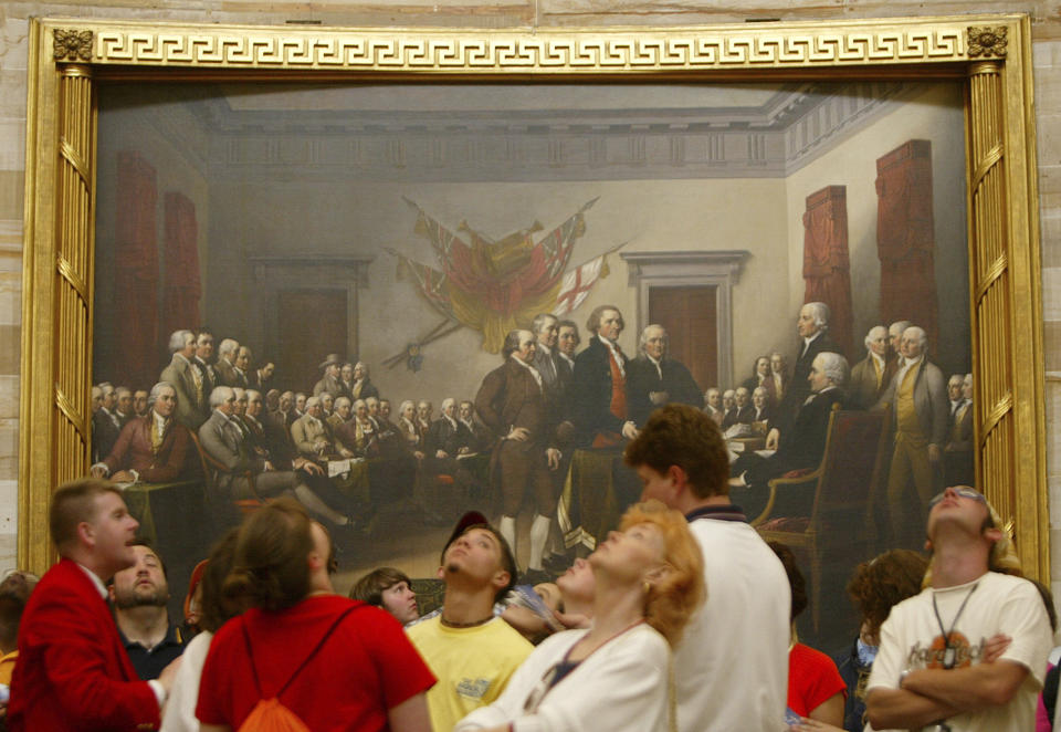 FILE - In this Thursday, May 15, 2003 file photo, visitors tour the Capitol Rotunda near John Trumbull's painting titled "Declaration of Independence, July 4th, 1776". On that day, the Continental Congress formally endorsed the Declaration of Independence. Celebrations began within days: parades and public readings, bonfires and candles and the firing of 13 musket rounds, one for each of the original states. Nearly a century passed before the country officially named its founding a holiday. (AP Photo/Charles Dharapak)