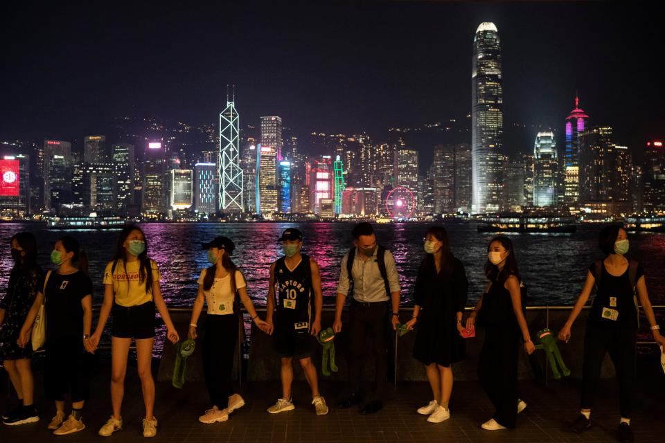 People form a human chain in support of protest movement in the harbor area in Hong Kong, Monday, Sept. 30, 2019.