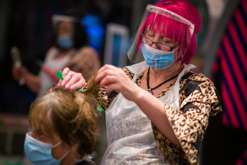 Owner Carole Rickaby cuts customer Sandra Jacobs' hair at Tusk Hair stylists in Camden (Getty Images)