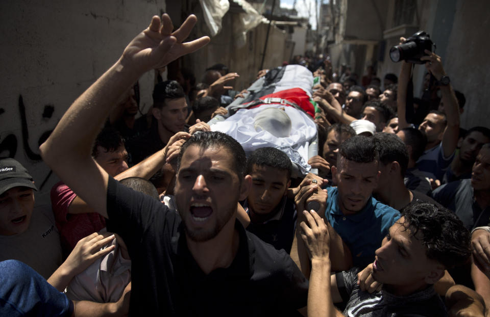 CORRECTS AGE FROM 12 TO 11 -Palestinian mourners carry the body of 11 year-old boy, Majdi al-Satari, who was shot and killed by Israeli troops on Friday's ongoing protest at the Gaza Strip's border with Israel, during his funeral in town of Rafah, Southern Gaza Strip, Saturday, July 28, 2018. Gaza health officials said two Palestinians were killed and dozens injured by Israeli fire at a weekly border protest on Friday. (AP Photo/Khalil Hamra)