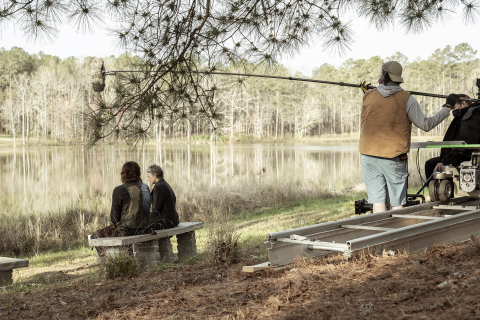 This image released by AMC shows Norman Reedus as Daryl Dixon, left, and Melissa McBride as Carol Peletier on location in Georgia during the filming of season 11 of "The Walking Dead." (Jace Downs/AMC via AP)