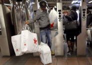 Shoppers enter the Herald Square Subway station after early morning Black Friday Shopping in New York. REUTERS/Brendan McDermid