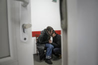 Marina Yatsko and her boyfriend Fedor comfort each other after her 18-month-old son Kirill was killed by shelling in a hospital in Mariupol, Ukraine, Friday, March 4, 2022. (AP Photo/Evgeniy Maloletka)