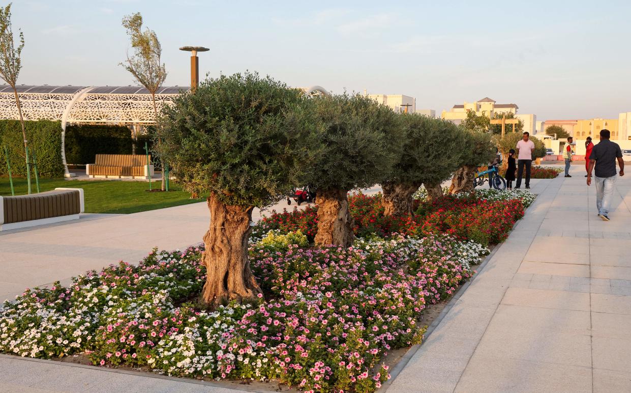 People gather at the Umm Al Seneem Park, which has the world's longest air-conditioned outdoor path, in Doha on November 2, 2022. (Photo by KARIM JAAFAR / AFP) (Photo by KARIM JAAFAR/AFP via Getty Images)