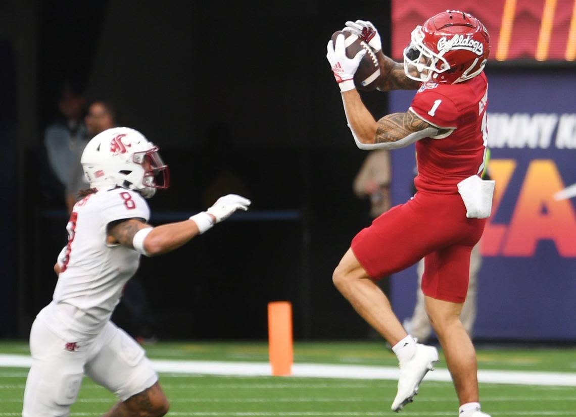 Fresno State’s Nikko Remigio, right, makes the catch covered by Washington State’s Armani Marsh, left, at the Jimmy Kimmel LA Bowl Saturday, Dec. 17, 2022 in Inglewood, CA.