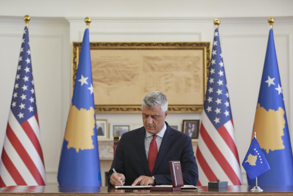 Kosovo's President Hashim Thaci signs the Order of Freedom awarded to U.S President Donald Trump, in capital Pristina, Kosovo on Friday, Sept. 18, 2020. Kosovo's president awarded U.S. President Donald Trump with one of the country's highest medals - Kosovo's Order of Freedom - for his government's efforts on peace and reconciliation in the former war-torn region. (AP Photo/Visar Kryeziu)