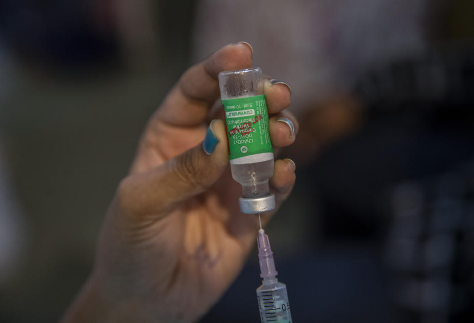 A doctor fills a syringe with a vial of the Covishield COVID-19 vaccine at a vaccination center in Mumbai, India, Thursday, Sept. 23, 2021. (AP Photo/Rafiq Maqbool)