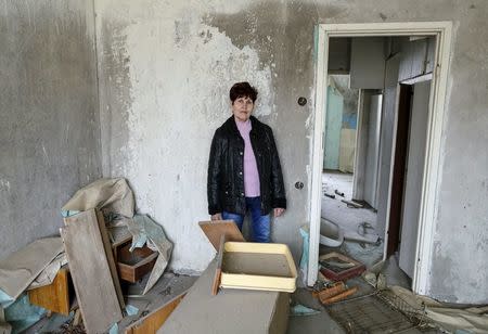 Zoya Perevozchenko, 66, poses for a photograph in her house which was evacuated after an explosion at the Chernobyl nuclear power plant, in the ghost town of Pripyat, Ukraine April 5, 2016. REUTERS/Gleb Garanich