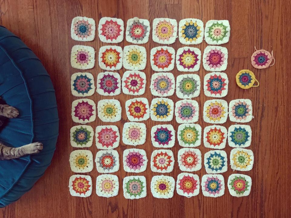 Tiny Colorful Granny Squares Crocheted and Spread Out on the Floor