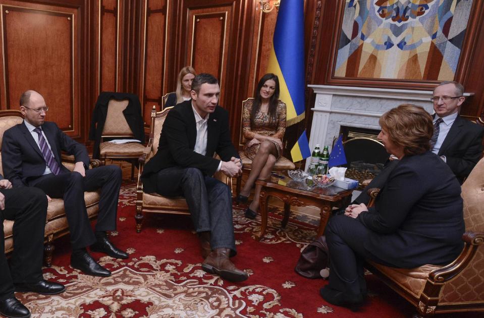 Ukrainian opposition leader Arseniy Yatsenyuk, left, and Ukrainian lawmaker and chairman of the Ukrainian opposition party Udar (Punch), former WBC heavyweight boxing champion Vitali Klitschko, foreground center, during their talks with EU foreign policy chief Catherine Ashton, foreground right, during their talks in Kiev, Ukraine, Monday, Feb. 24, 2014.The head of the European security organization, OSCE is proposing the establishment of an international contact group to support Ukraine in its difficult transition period.(AP Photo/Andrew Kravchenko, Pool)