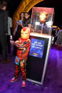 <p>A young fan in an <em>Iron Man</em> ensemble perfectly posed with RDJ’s mask. (Photo: Getty Images) </p>