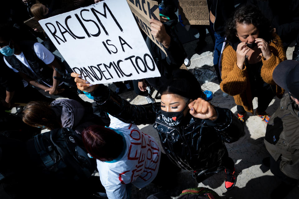  A protester holds a placard that says Racism Is A Pandemic Too during the demonstration. Several protest have been sparked by the recent killing of George Floyd, a black man who died in police custody in Minneapolis, U.S.A. (Photo by Andy Barton / SOPA Images/Sipa USA) 