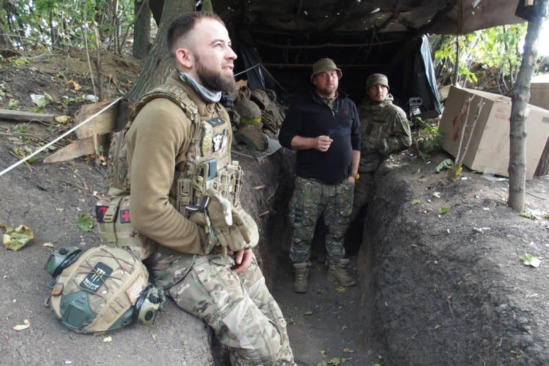 Ukrainian soldiers wait for orders to fire on Russian lines in a dugout along the Donetsk frontline. Photo by Patrick Hilsman/UPI