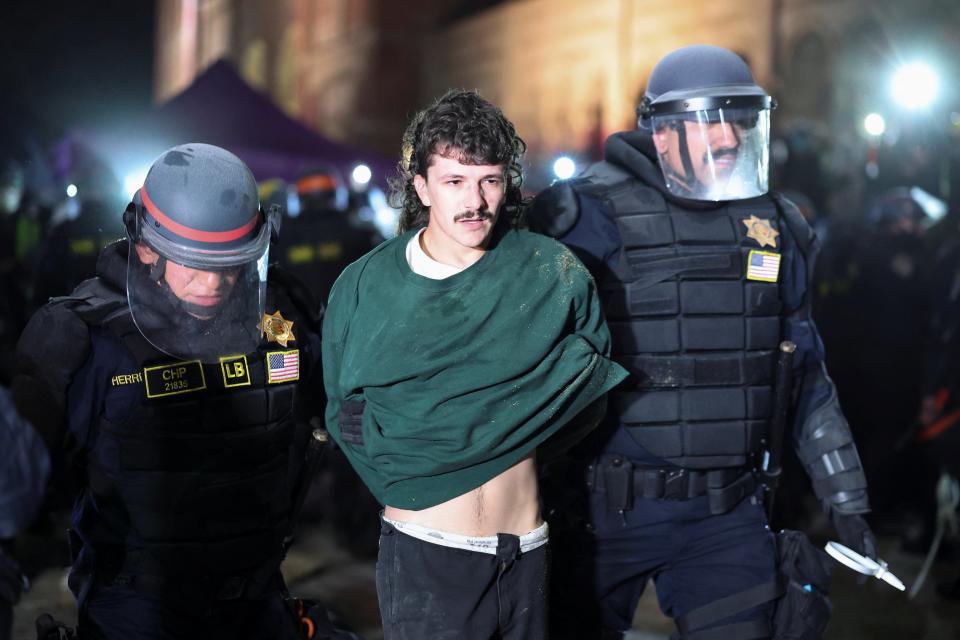 Law enforcement officers detain a protester at the University of California Los Angeles (UCLA) (REUTERS)