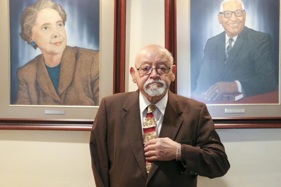 Jim Goodwin with paintings of his mother and father, Jeanne and E.L. Goodwin, in the lobby of the Oklahoma Eagle newspaper.