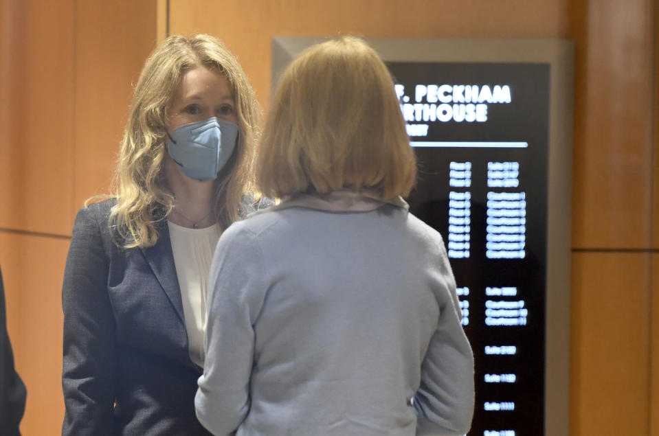 Elizabeth Holmes walks into the federal courthouse for her trial in San Jose, Calif., Wednesday, Sept. 8, 2021. Holmes is accused of duping elite financial backers, customers and patients into believing that her startup was about to revolutionize medicine. If convicted by a jury, she could be sentenced to 20 years in prison. (AP Photo/Nic Coury)