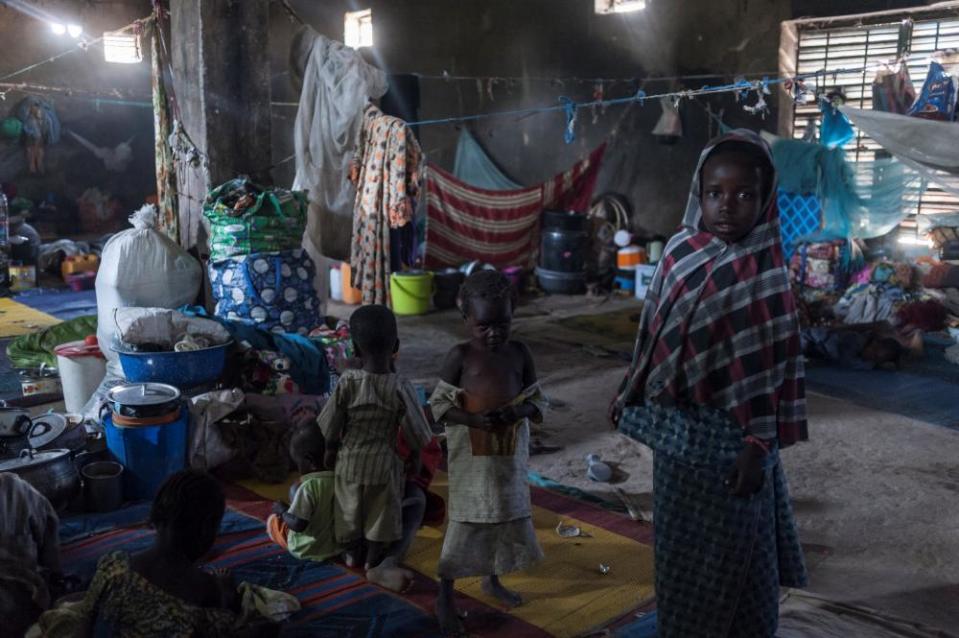 Children take refuge from the sun inside a warehouse made available for internally displaced people in Maiduguri, north-eastern Nigeria.