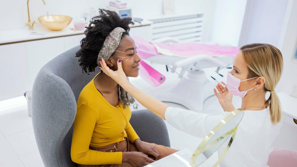 Woman in consultation with a doctor aesthetician in beauty hospital