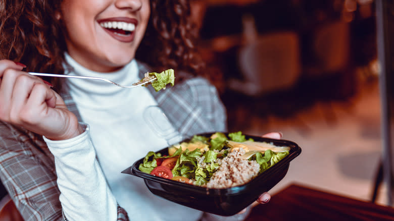 woman eating tuna on a salad