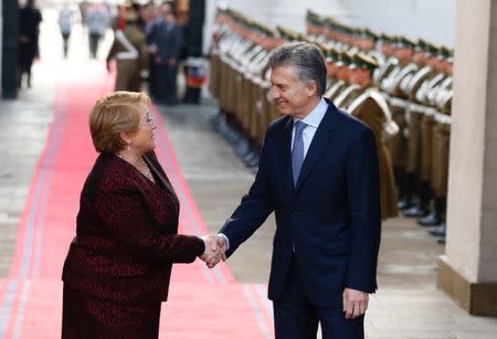 Chile's President Michelle Bachelet and Argentina's President Mauricio Macri shake hands at the Presidential House during Macri's official visit in Santiago, Chile June 27, 2017. REUTERS/Rodrigo Garrido