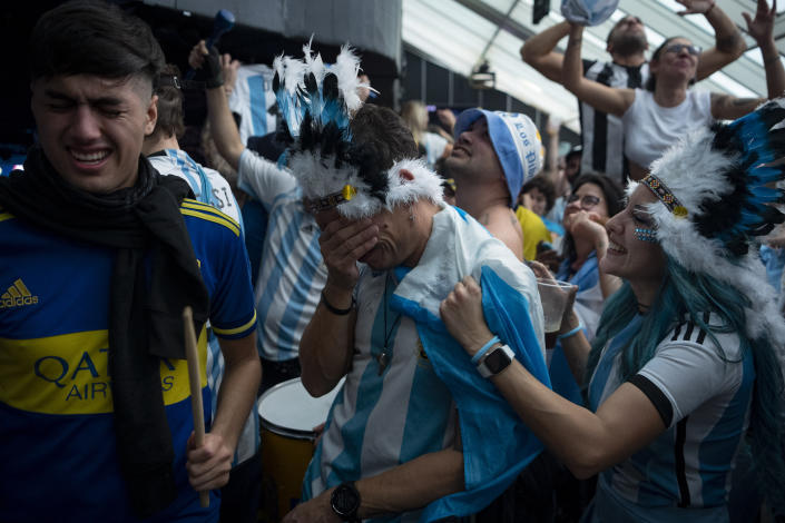 BARCELONA, SPAIN - DECEMBER 18:  Argentinian fans watch a live broadcast of the Qatar 2022 World Cup finals football match between France and Argentina at a discotheque in Barcelona on December 18, 2022. (Photo by Adria Puig/Anadolu Agency via Getty Images)