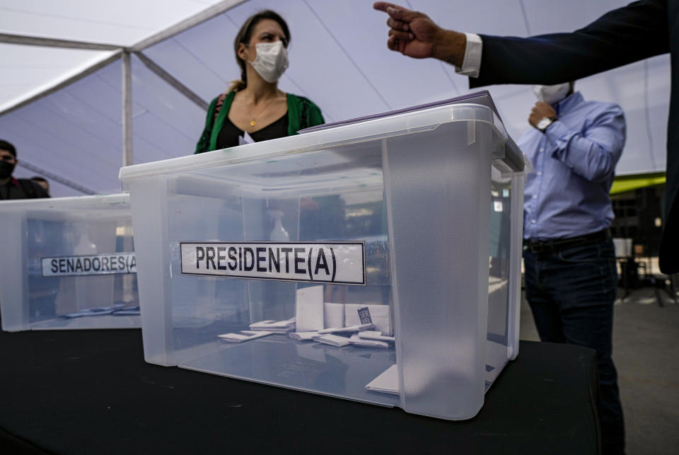 Electoral workers train at a school that will serve as a polling station for Sunday's general elections, including presidential, in Santiago, Chile, Friday, Nov. 19, 2021. (AP Photo/Esteban Felix)