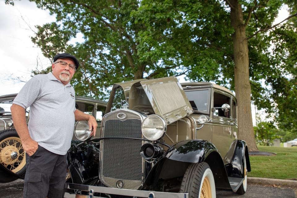 Floral City Model A Club President Dave Jones proudly stands with his 1931 Ford Model A Victoria.