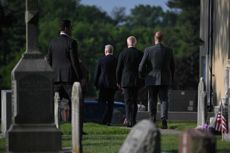 President Joe Biden, second from right, visits the grave of his son Beau in Wilmington, Del., on May 30.