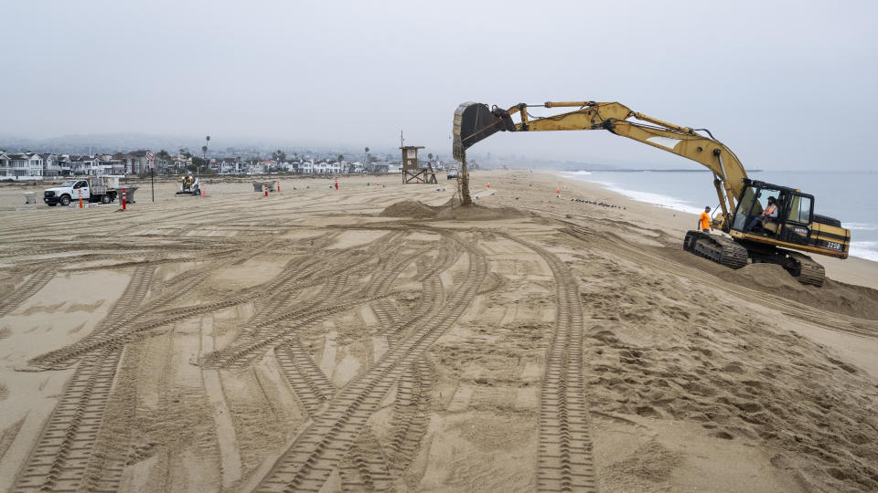 Workers build a berm near the Balboa Pier in Newport Beach, California, on Aug. 18, 2023. Cities along the coast were preparing for potential high surf as the effects of Hurricane Hilary move north. / Credit: Paul Bersebach/MediaNews Group/Orange County Register via Getty Images