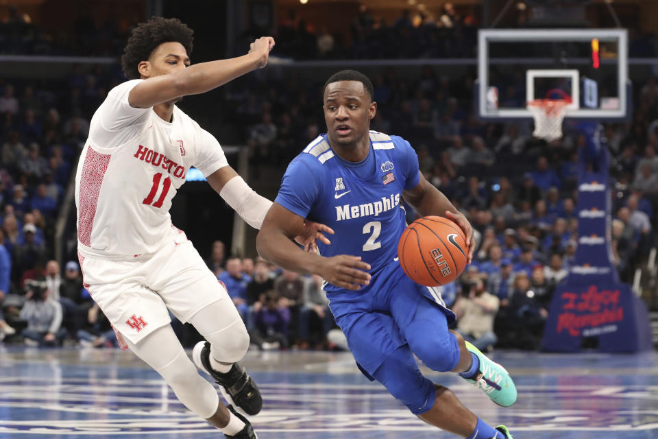 Memphis guard Alex Lomax (2) heads to the basket as Houston guard Nate Hinton defends in the second half of an NCAA college basketball game Saturday, Feb. 22, 2020, in Memphis, Tenn. (AP Photo/Karen Pulfer Focht)