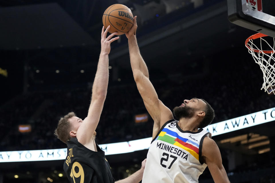 Minnesota Timberwolves center Rudy Gobert (27) blocks a shot by Toronto Raptors center Jakob Poeltl (19) during the first half of an NBA basketball game, in Toronto, Saturday, March 18, 2023. (Frank Gunn/The Canadian Press via AP)