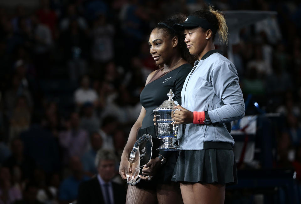 Serena Williams, left, and Naomi Osaka, of Japan, pose for photos during the trophy ceremony after Osaka defeated Williams in the women's final of the U.S. Open tennis tournament, Saturday, Sept. 8, 2018, in New York. (AP Photo/Andres Kudacki)