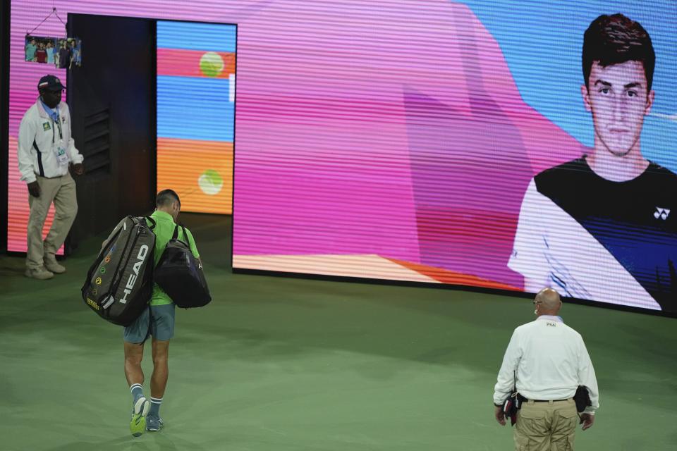 Novak Djokovic, of Serbia, walks off the court after being upset by Luca Nardi, of Italy, at the BNP Paribas Open tennis tournament Monday, March 11, 2024, in Indian Wells, Calif. Nardi won 6-4, 3-6, 6-3. (AP Photo/Mark J. Terrill)