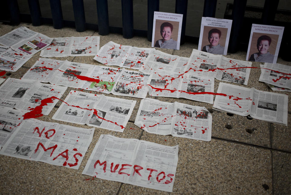 A message that reads in Spanish: “No More Deaths” is written in red paint on newspapers placed in front of photos of Mexican journalist Miroslava Breach, who was gunned down in the northern state of Chihuahua on Thursday, at headquarters of Mexico's General Attorney's Office in Mexico City, Saturday, March 25, 2017. Breach was the third journalist to be killed this month in one of the most dangerous countries for media workers. (AP Photo/Eduardo Verdugo)