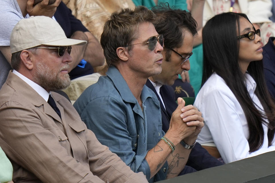 Actor Brad Pitt and director Guy Ritchie sit in the stands on Centre Court for the final of the men's singles between Spain's Carlos Alcaraz and Serbia's Novak Djokovic on day fourteen of the Wimbledon tennis championships in London, Sunday, July 16, 2023. (AP Photo/Alastair Grant)