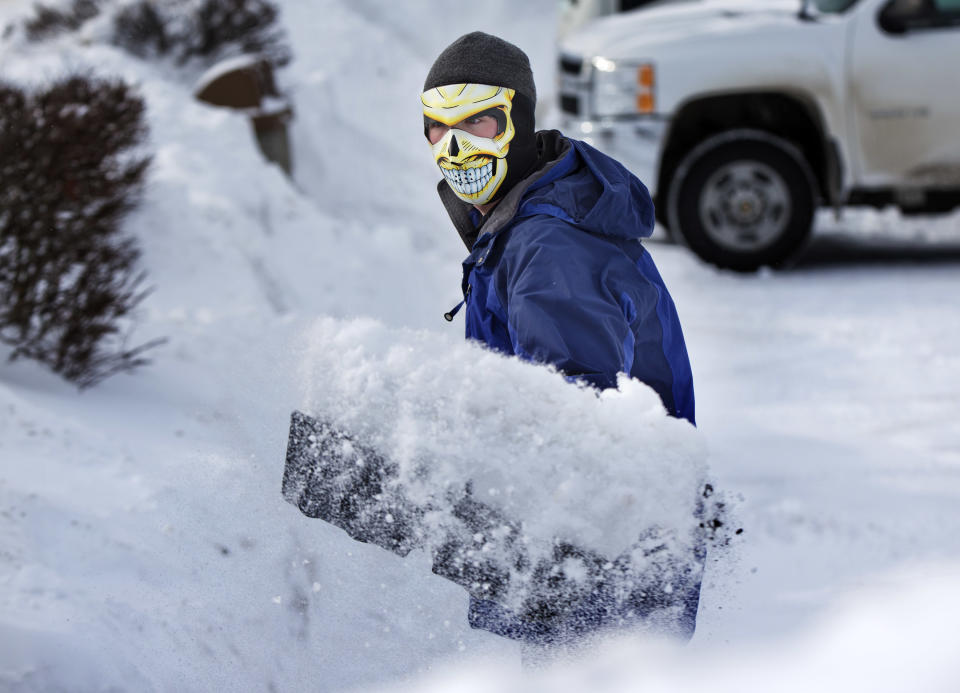 Drue Ford retira nieve con una mascara de calavera en Brunswick, Maine, en una fotografía del Viernes 3 de enero de 2014. (Foto AP/Robert F. Bukaty)