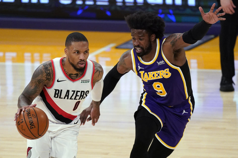 Los Angeles Lakers guard Wesley Matthews (9) defends against Portland Trail Blazers guard Damian Lillard (0) during the first half of an NBA basketball game Friday, Feb. 26, 2021, in Los Angeles. (AP Photo/Mark J. Terrill)