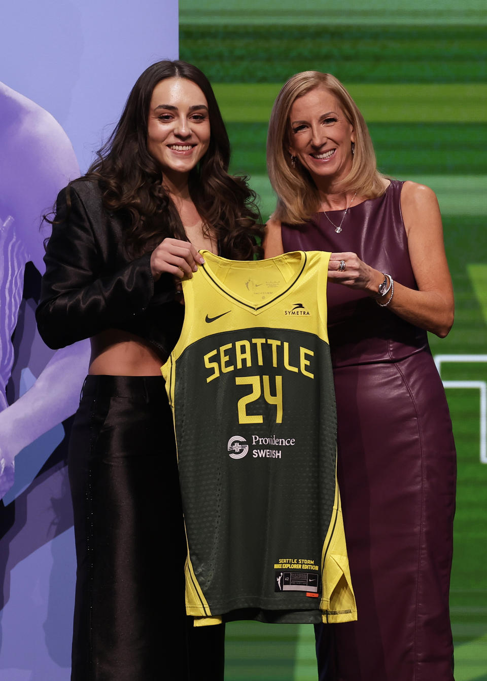 UConn's Nika Muhl, left, poses for a photo with WNBA commissioner Cathy Engelbert, right, after being selected 14th overall by the Seattle Storm during the second round of the WNBA basketball draft Monday, April 15, 2024, in New York. (AP Photo/Adam Hunger)