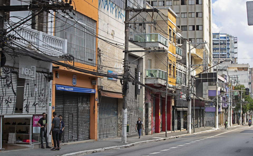 Stores remain closed along Teodoro Sampaio street during a quarantine imposed by Sao Paulo's government to help stop the spread of the new corona virus in Sao Paulo, Brazil, Monday, March 30, 2020. (AP Photo/Andre Penner)