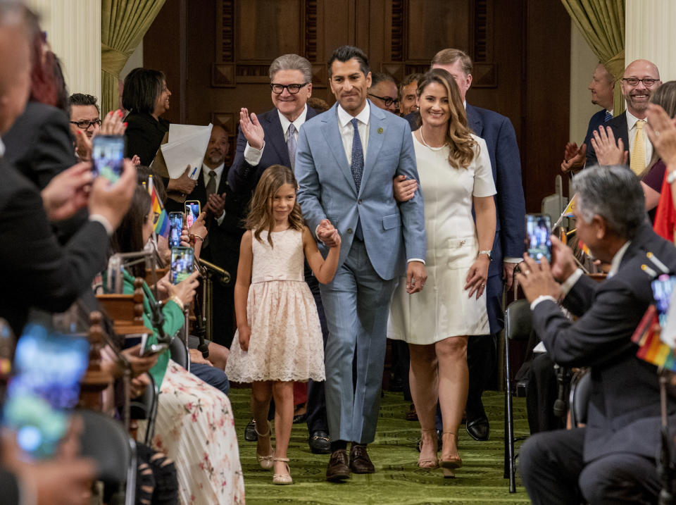 FILE - Assembly Speaker Robert Rivas, D-Hollister, accompanied by his daughter Melina, 7 and his wife, Christen, right, walks down the center isle of the California Assembly Chambers to be sworn-in as the 71st Assembly Speaker at the Capitol in Sacramento, Calif., Friday, June 30, 2023. Rivas has said little about his specific priorities as speaker but has emphasized the importance of a unified caucus. (AP Photo/Rich Pedroncelli, File)