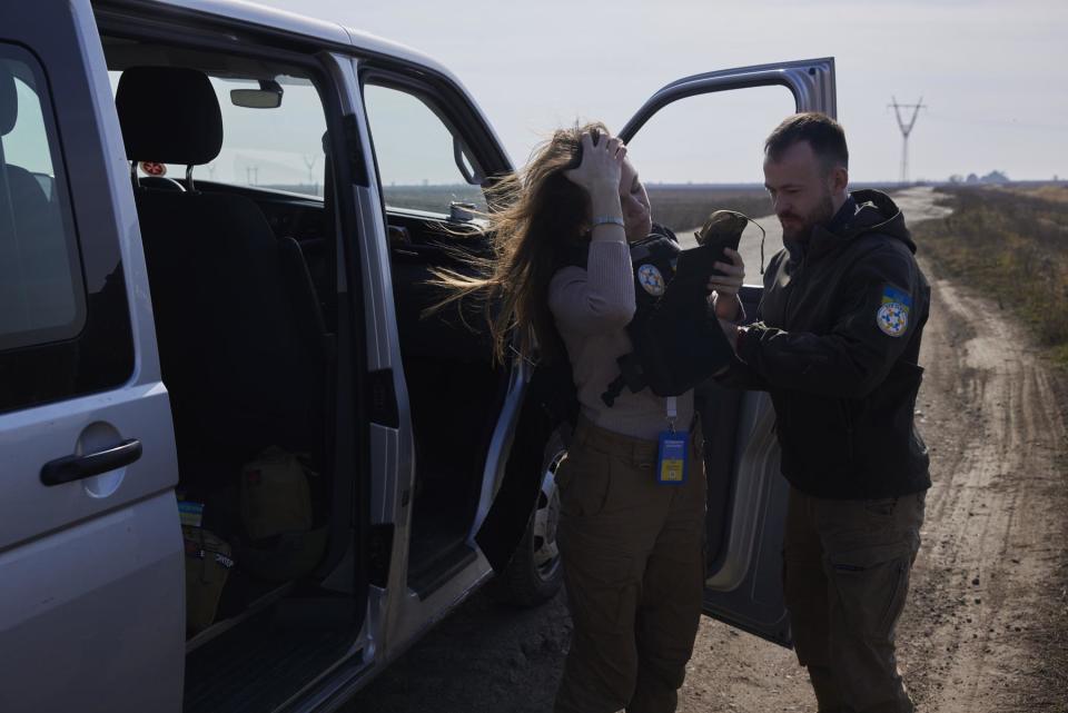 Julia and Oleg, two members of New Dawn, don their flak jackets ahead of travelling to villages in close proximity to Russian positions in Kherson Oblast, Ukraine on March 8, 2023.