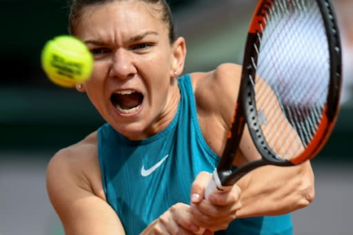 Power-packed: Top seed Simona Halep returns the ball to Belgium's Elise Mertens during their fourth round match on Monday