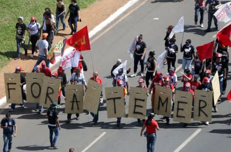 Demonstrators take part in a protest against Brazilian President Michel Temer and the latest corruption scandal to hit the country, in Brasilia, Brazil, May 24, 2017. The sign reads