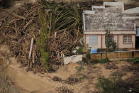 <p>Debris left by a flooded river is piled against a home, seen from the air, during recovery efforts following Hurricane Maria near Utuado, Puerto Rico, Oct.10, 2017. (Photo: Lucas Jackson/Reuters) </p>