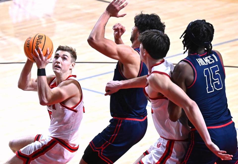 Davidson Wildcats guard Grant Huffman, left, drives to the basket for a shot against the Dayton Flyers at Belk Arena in Davidson, NC on Wednesday, January 3, 2024. The Flyers defeated the Wildcats 72-59.