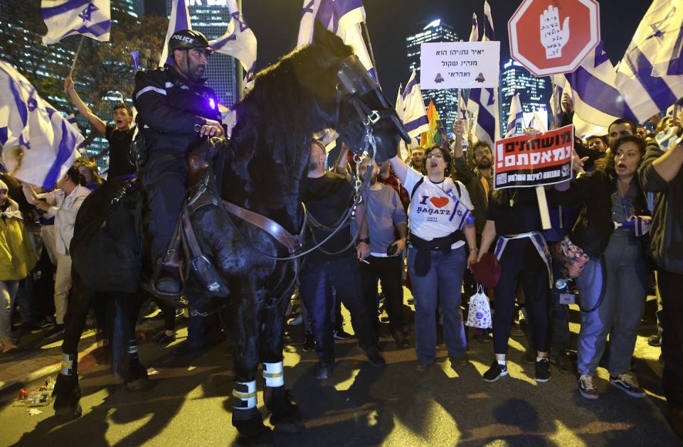 A mounted Israeli policeman stands guard at a protest in Tel Aviv on March 27, 2023. <a href="https://www.gettyimages.com/detail/news-photo/mounted-israeli-policeman-stands-guard-as-protesters-attend-news-photo/1249642348?adppopup=true" rel="nofollow noopener" target="_blank" data-ylk="slk:Photo by Gil Cohen-MAGEN/AFP via Getty Images;elm:context_link;itc:0;sec:content-canvas" class="link ">Photo by Gil Cohen-MAGEN/AFP via Getty Images</a>